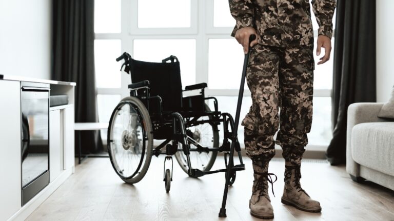 soldier is leaning on a crutch