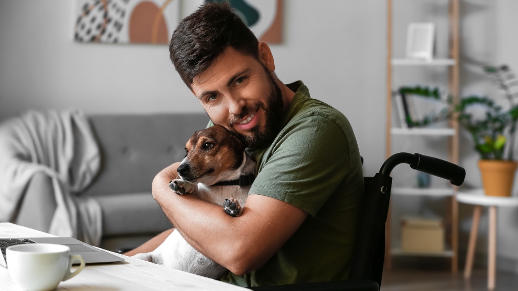 veteran in wheelchair with dog at home